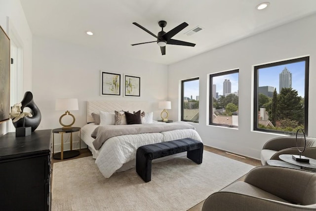 bedroom featuring recessed lighting, baseboards, visible vents, and wood finished floors