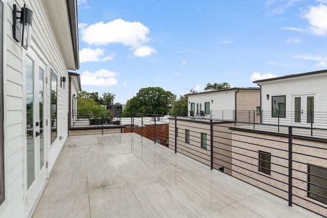 view of patio with french doors and a balcony