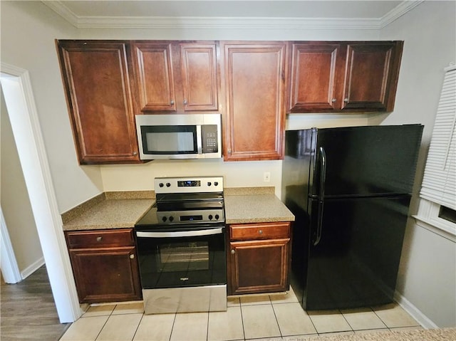 kitchen with appliances with stainless steel finishes, baseboards, and ornamental molding