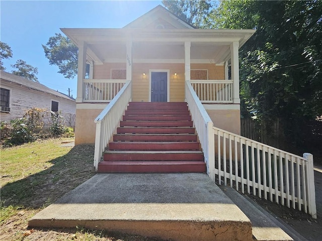 view of front facade featuring a porch and stairs