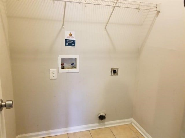 clothes washing area featuring baseboards, light tile patterned floors, laundry area, hookup for a washing machine, and electric dryer hookup