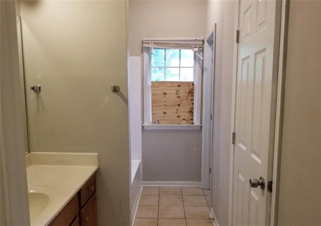 full bathroom featuring vanity, baseboards, walk in shower, tile patterned floors, and a bathtub