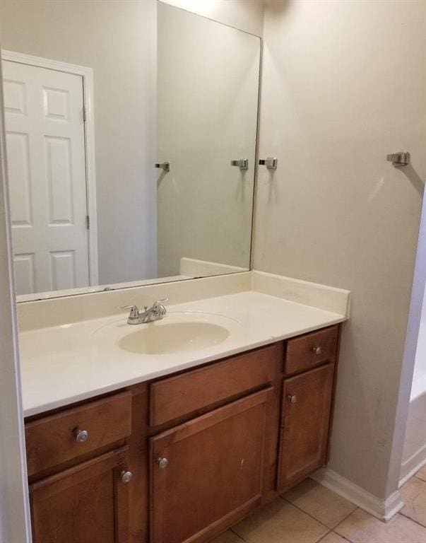 bathroom featuring vanity, tile patterned floors, and baseboards