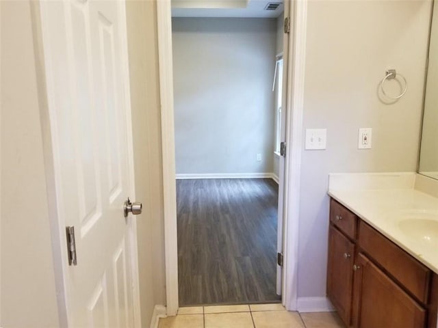 bathroom with vanity, tile patterned floors, visible vents, and baseboards