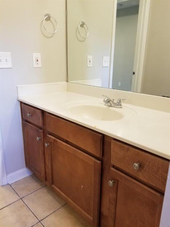 bathroom featuring tile patterned flooring and vanity