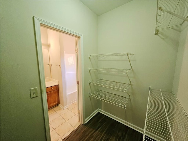 spacious closet with dark wood-type flooring