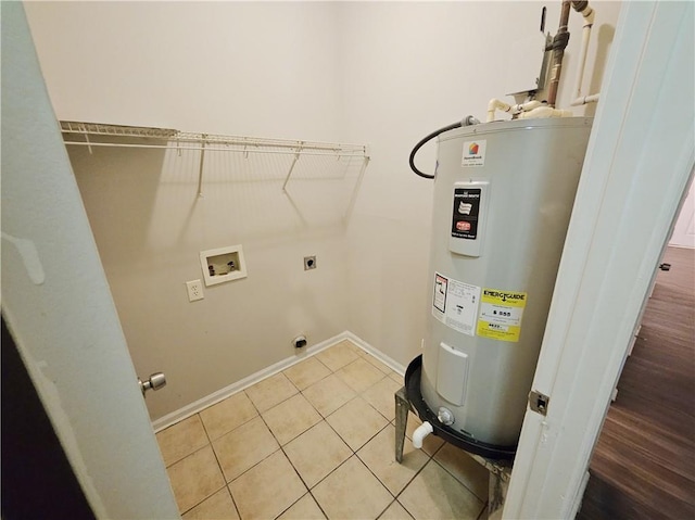 washroom featuring light tile patterned floors, hookup for an electric dryer, laundry area, washer hookup, and electric water heater