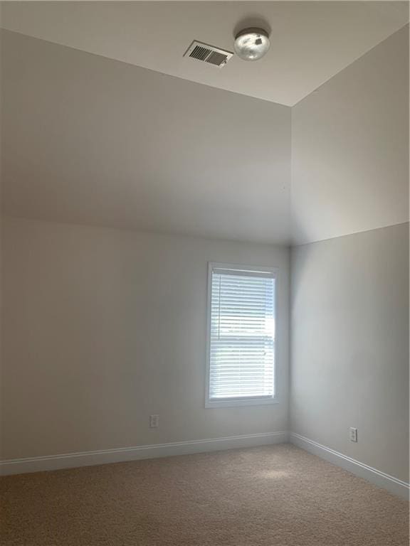 additional living space with carpet flooring and vaulted ceiling