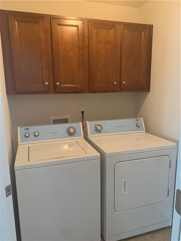 washroom featuring cabinets and washer and dryer