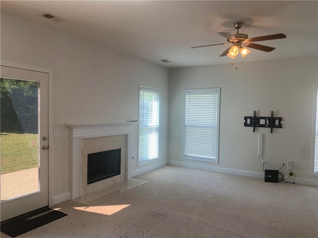 unfurnished living room with ceiling fan and light carpet