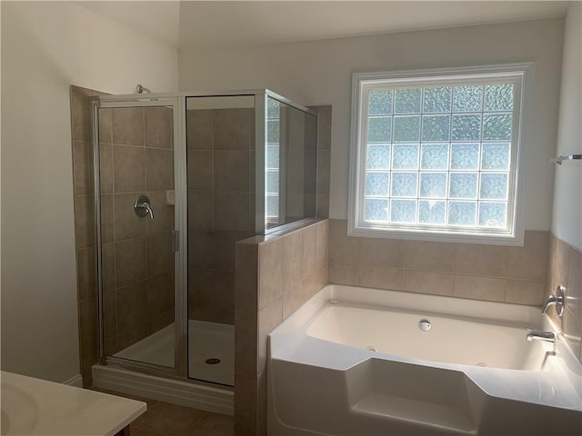 bathroom with shower with separate bathtub, vanity, tile patterned floors, and plenty of natural light