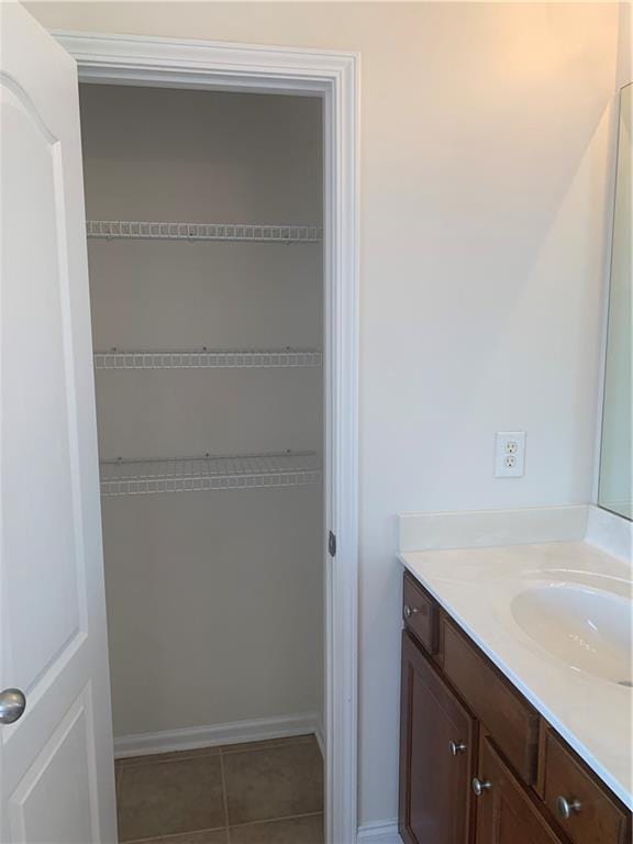 bathroom with tile patterned flooring and vanity