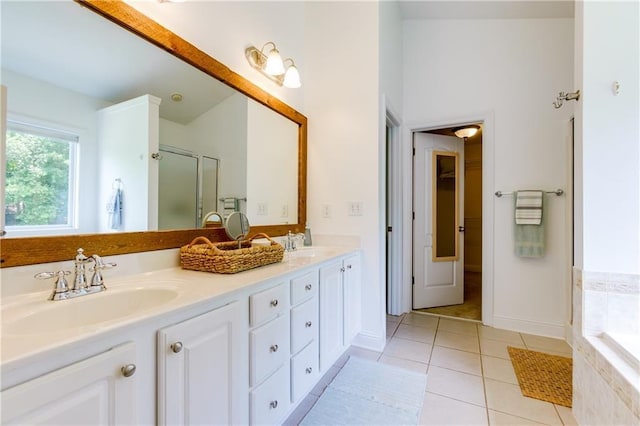 bathroom with shower with separate bathtub, vanity, and tile patterned floors