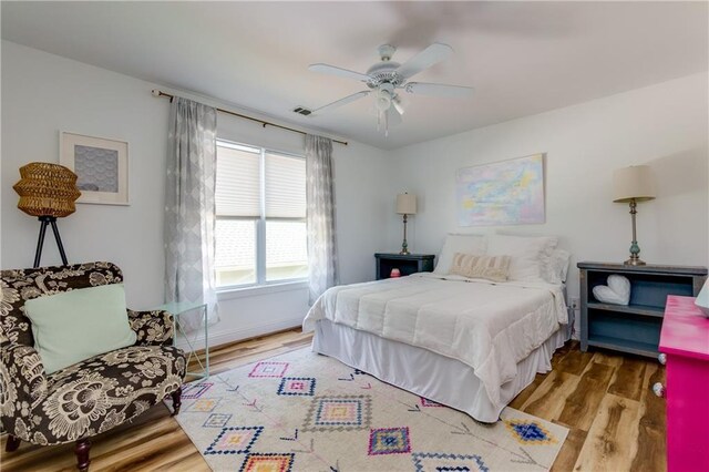 bedroom with hardwood / wood-style floors and ceiling fan