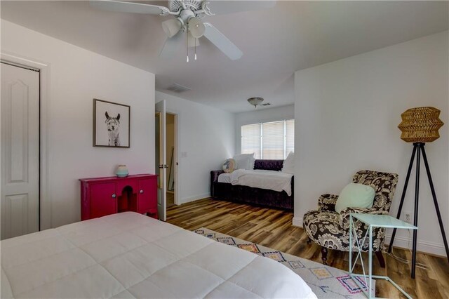 bedroom featuring a closet, hardwood / wood-style flooring, and ceiling fan