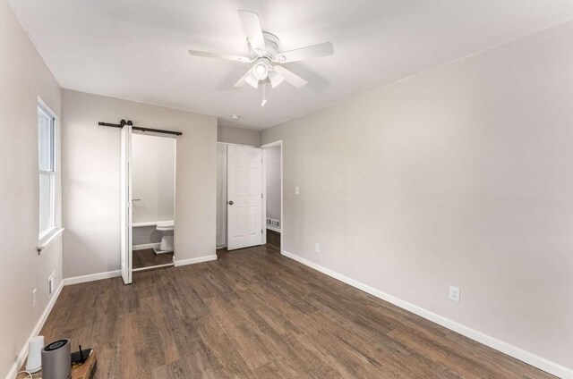 unfurnished bedroom with a ceiling fan, wood finished floors, visible vents, and baseboards