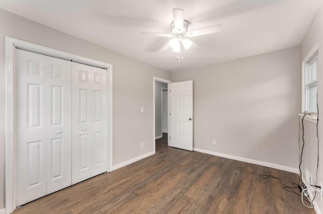 unfurnished bedroom with a ceiling fan, a closet, baseboards, and wood finished floors