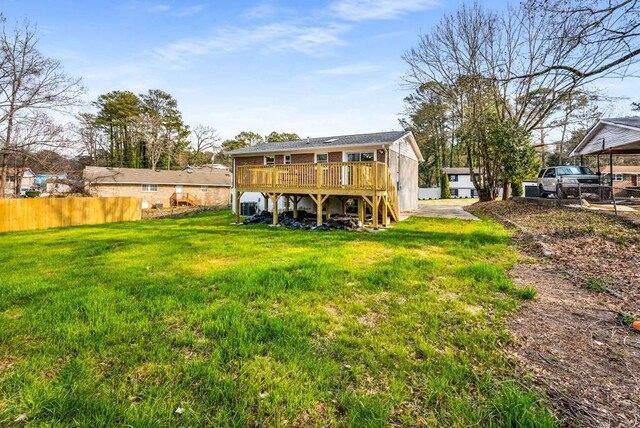 back of property featuring central AC, a deck, a lawn, and brick siding