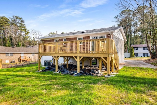 back of house with cooling unit, a yard, and a wooden deck