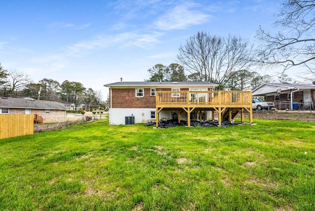 back of house with central AC unit, fence, a deck, a yard, and brick siding