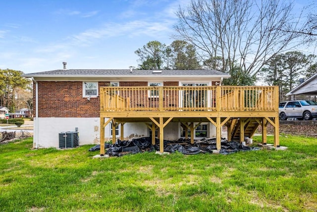 back of house featuring a yard, fence, and a wooden deck