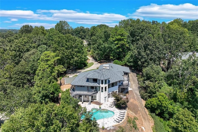 drone / aerial view featuring a forest view