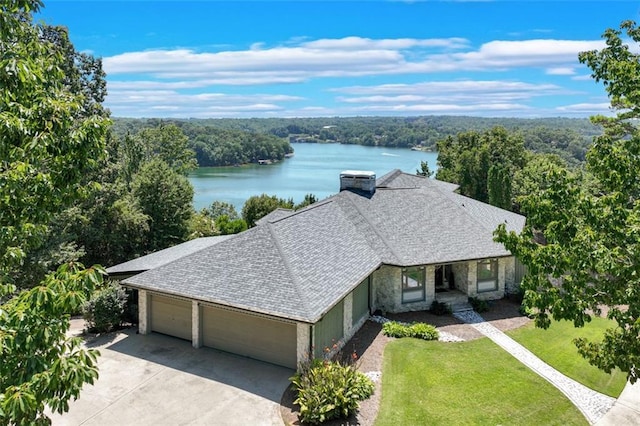 aerial view with a forest view and a water view