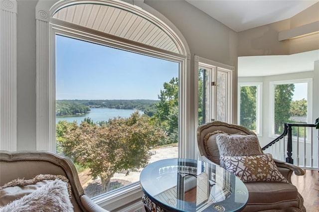 sunroom featuring a water view