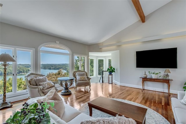 living area with high vaulted ceiling, wood finished floors, beam ceiling, and visible vents