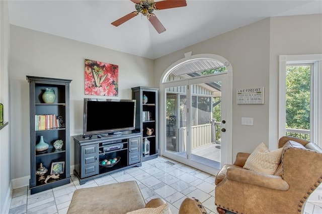 living room with baseboards and ceiling fan