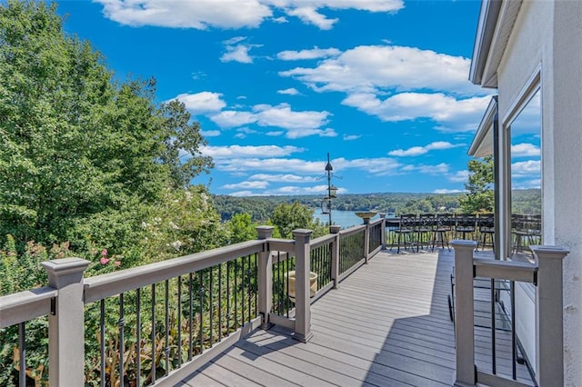 wooden terrace featuring a water view