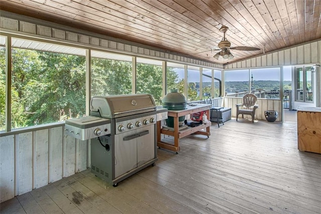 sunroom featuring wooden ceiling, a mountain view, ceiling fan, and lofted ceiling