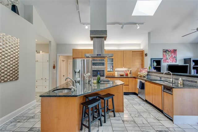 kitchen featuring track lighting, marble finish floor, appliances with stainless steel finishes, and a sink