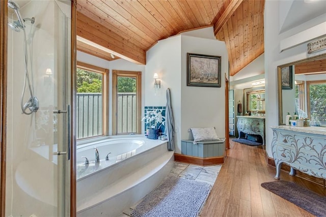 bathroom featuring lofted ceiling, wooden ceiling, a healthy amount of sunlight, and a stall shower