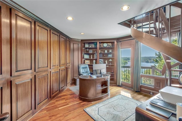 home office featuring light hardwood / wood-style flooring and built in features