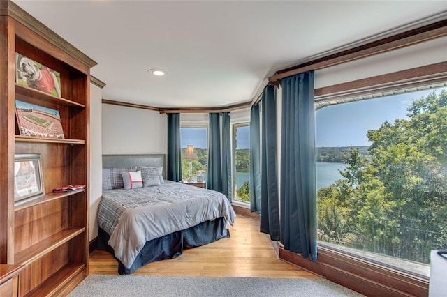 bedroom with ornamental molding, wood finished floors, multiple windows, and recessed lighting