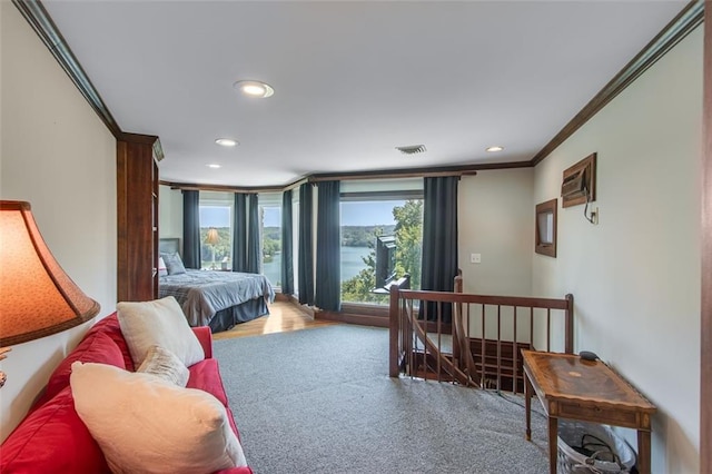 carpeted bedroom with ornamental molding and recessed lighting
