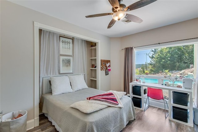 bedroom with visible vents, wood finished floors, and ceiling fan
