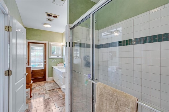 full bathroom with a shower stall, visible vents, toilet, and vanity