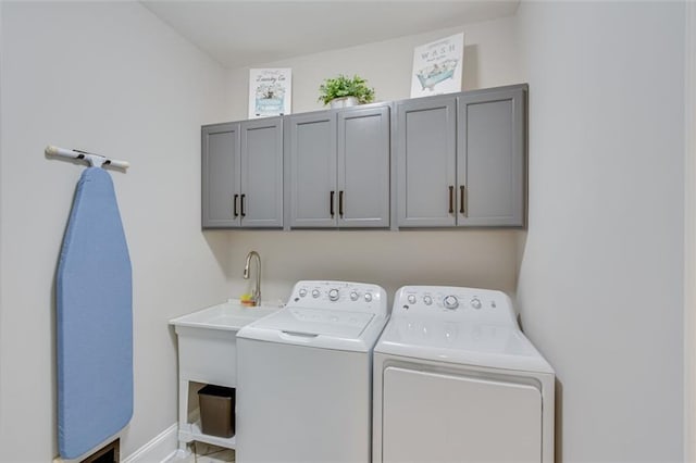 laundry area featuring independent washer and dryer and cabinets