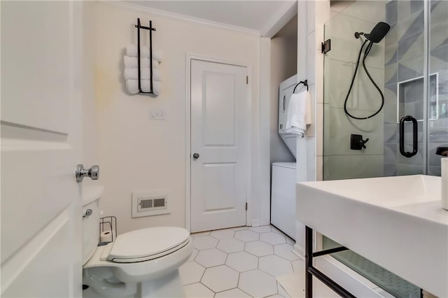 bathroom featuring crown molding, sink, tile patterned flooring, toilet, and a shower with shower door