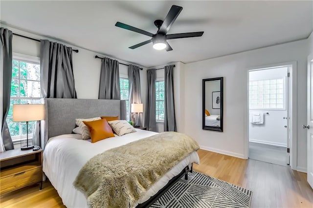 bedroom featuring multiple windows, ceiling fan, and light wood-type flooring