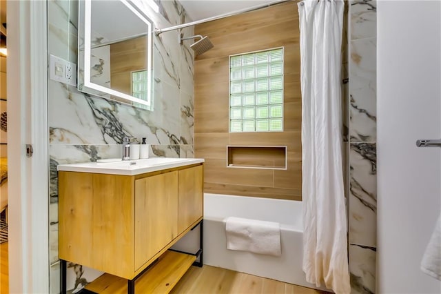 bathroom with shower / bath combination with curtain, vanity, and wood-type flooring