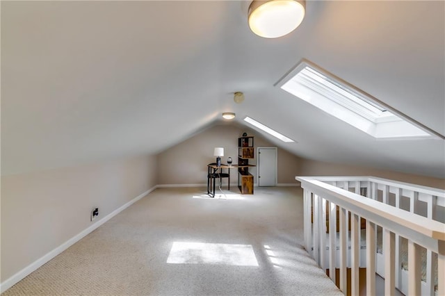 bonus room featuring vaulted ceiling with skylight and light carpet