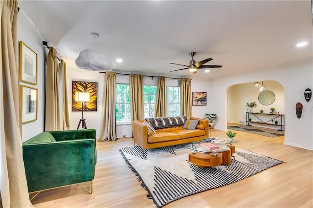 living room with hardwood / wood-style flooring and ceiling fan