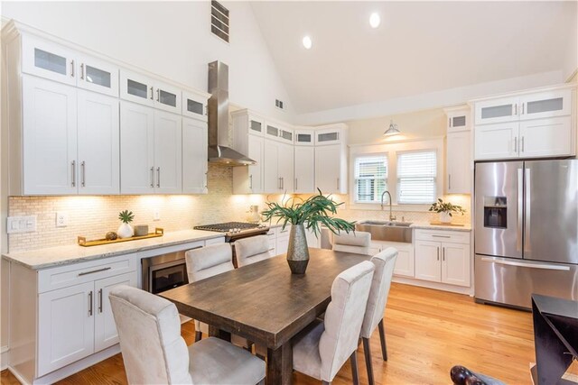 151 Savannah St SE, Atlanta, GA 30316 - kitchen with appliances with stainless steel finishes, wall chimney range hood, a sink, backsplash, and white cabinetry
