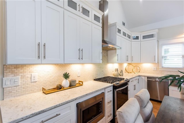 151 Savannah St SE, Atlanta, GA 30316 - kitchen with stainless steel appliances, wall chimney exhaust hood, vaulted ceiling, decorative backsplash, and white cabinets