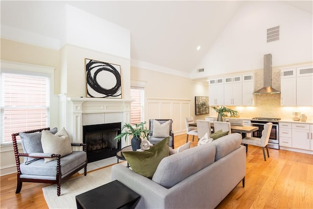 151 Savannah St SE, Atlanta, GA 30316 - living room featuring high vaulted ceiling, a fireplace, light wood-style flooring, and recessed lighting