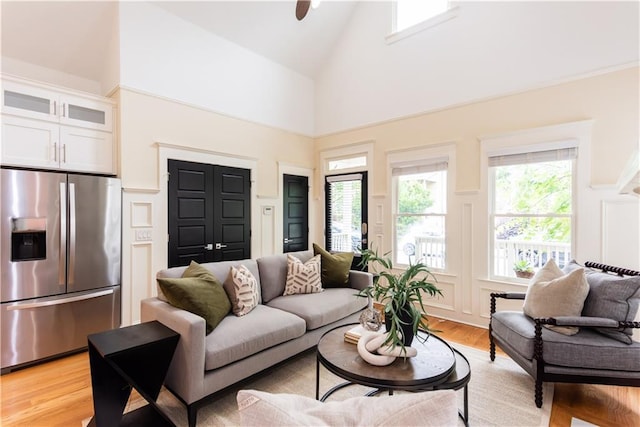 151 Savannah St SE, Atlanta, GA 30316 - living room with high vaulted ceiling, light wood finished floors, a decorative wall, and a ceiling fan