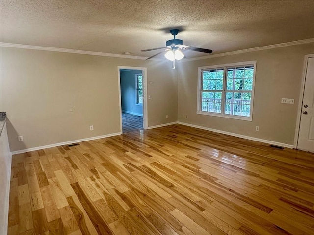 spare room with a textured ceiling, ceiling fan, crown molding, and light hardwood / wood-style flooring